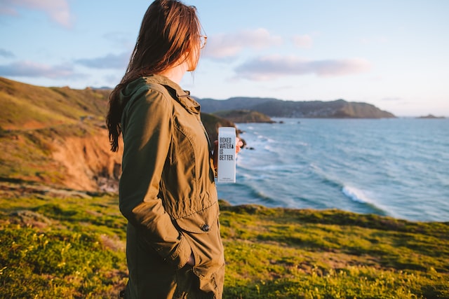 hiking woman drinking boxed water